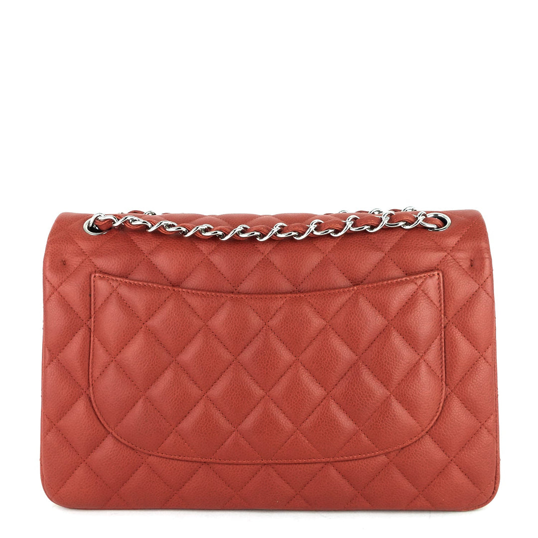 Quilted red handbag with a chain detail on a white background