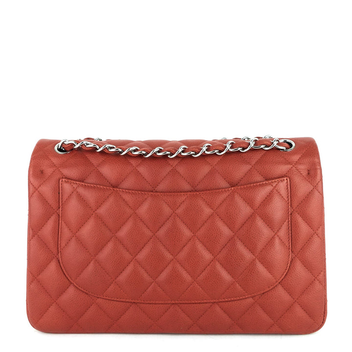 Quilted red handbag with a chain detail on a white background