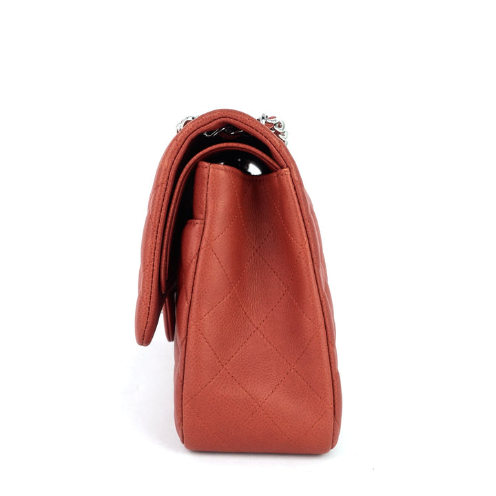 Brown leather handbag with a quilted pattern on a white background