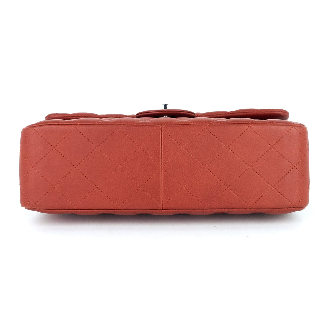 Brown quilted handbag on a white background