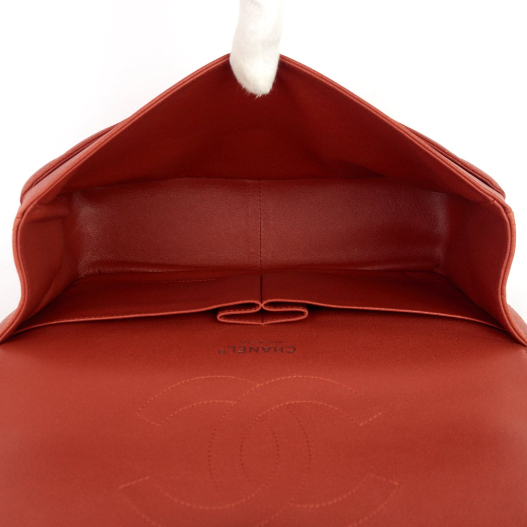 Close-up of a red Chanel handbag with the brand logo.