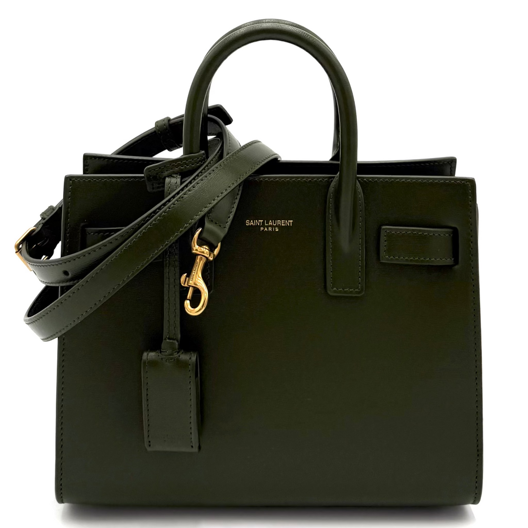Green handbag with gold clasp on a white background