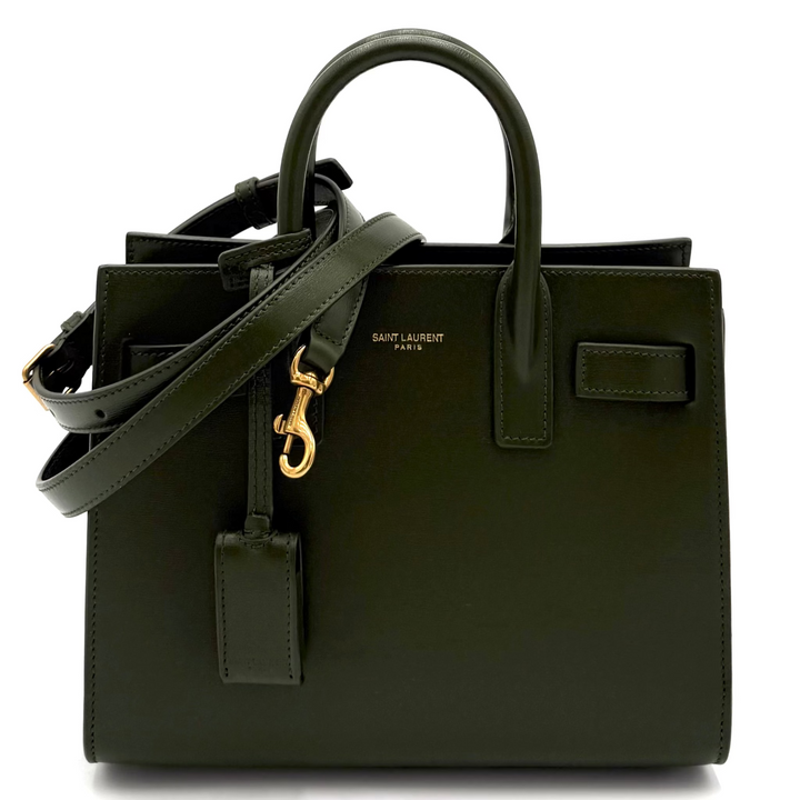 Green handbag with gold clasp on a white background