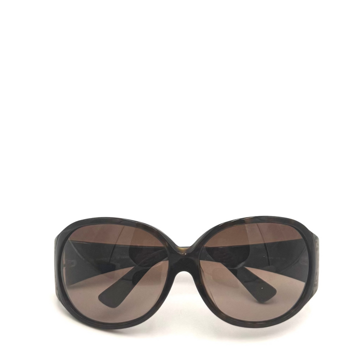 Oversized sunglasses with a thick black frame and brown-tinted lenses, shown against a plain white background.