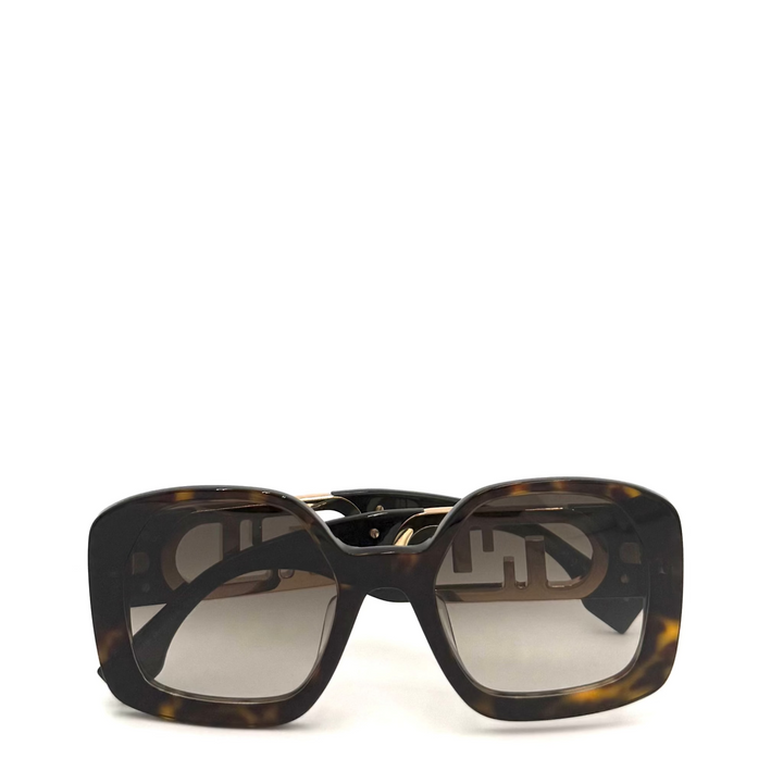 A pair of oversized square sunglasses with a dark brown and black tortoiseshell pattern and gradient gray lenses, set against a plain white background.