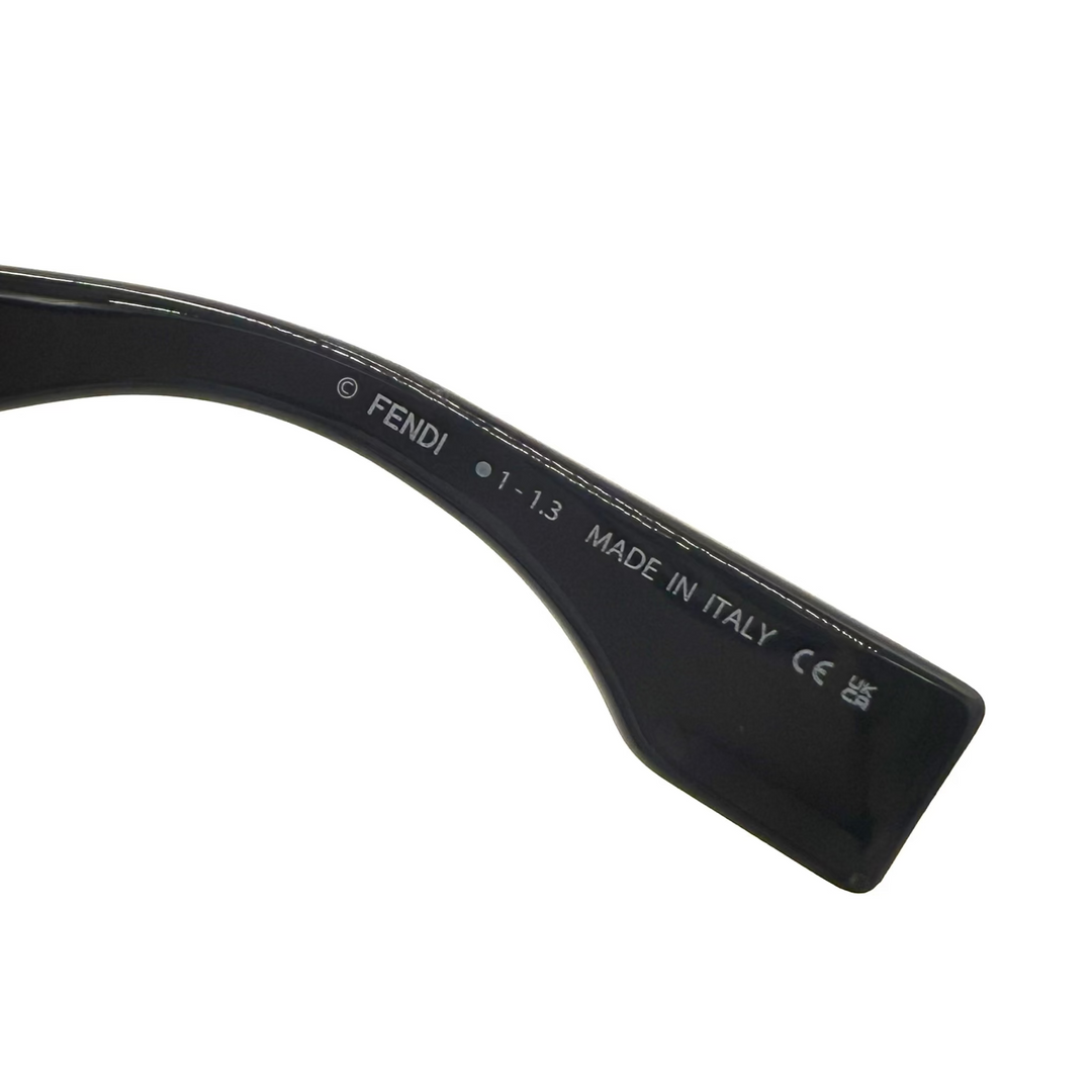 Close-up of a black Fendi eyeglass arm with white printed text including 'FENDI', '1-1.3', 'MADE IN ITALY', and certification marks, on a white background.