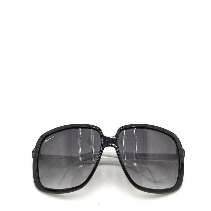 A pair of oversized square sunglasses with a thick black frame and dark gray gradient lenses, shown against a plain white background.