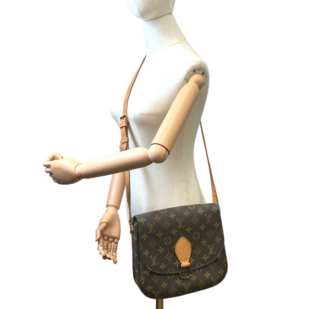 Louis Vuitton brown monogram shoulder bag displayed on a white mannequin torso with articulated wooden arms against a plain white background.