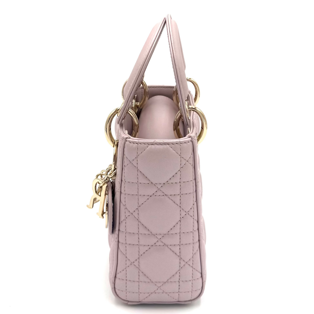 A light pink quilted leather handbag shown from the side profile against a plain white background.