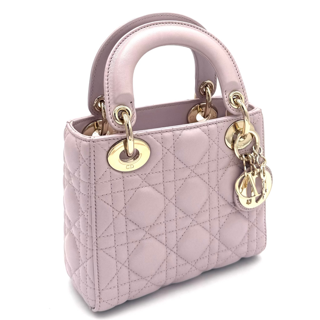 A small light pink quilted leather handbag with gold-tone hardware, shown on a plain white background.