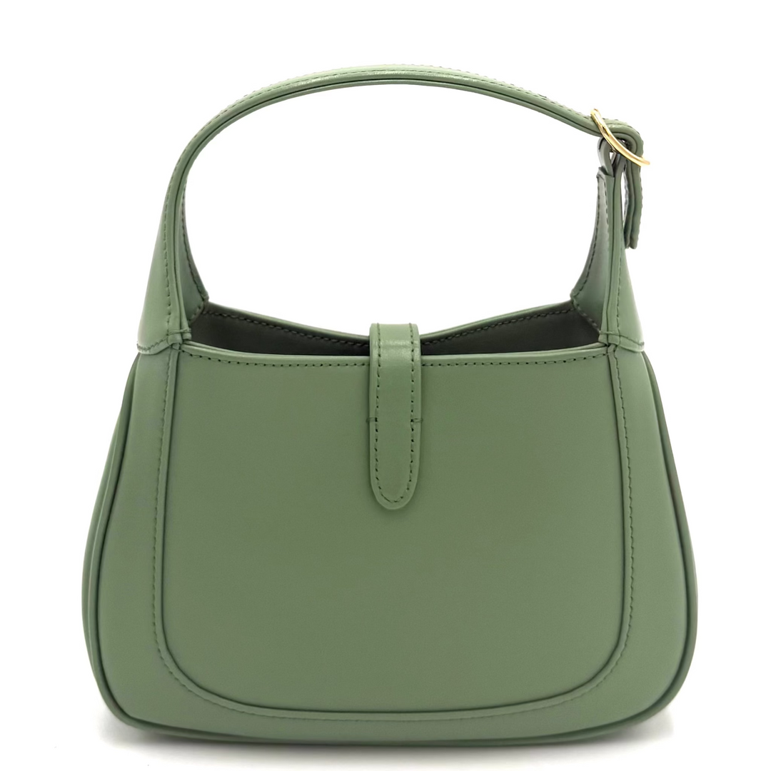 A sage green leather shoulder bag with a top handle and a small front strap detail, shown against a plain white background.