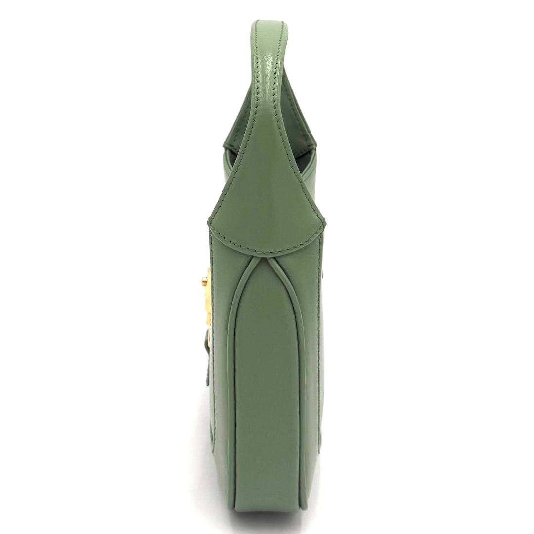 A sage green leather handbag shown from a top-down view on a plain white background.