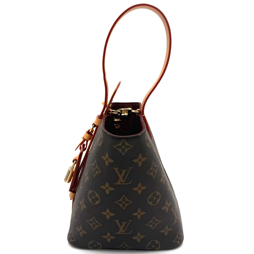 Louis Vuitton monogram canvas bucket bag with a single brown leather shoulder strap and gold-tone hardware, shown against a plain white background.