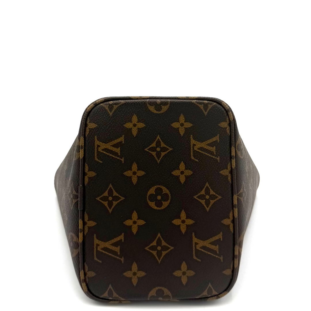 Louis Vuitton monogram canvas handbag shown from the back, featuring the classic dark brown and tan LV pattern on a white background.