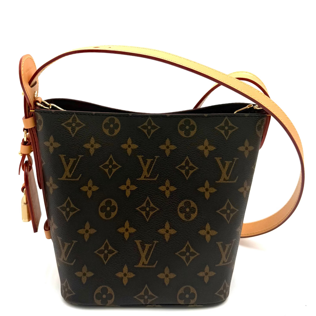 Louis Vuitton monogram canvas shoulder bag in black with tan leather trim and strap, shown on a white background.