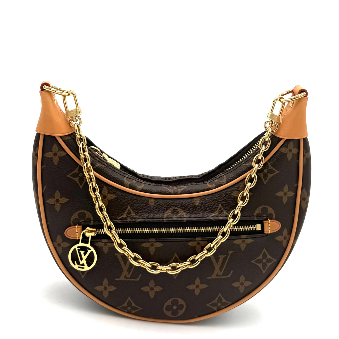 Louis Vuitton monogram crescent shoulder bag with tan leather trim and a gold chain strap, shown on a white background.