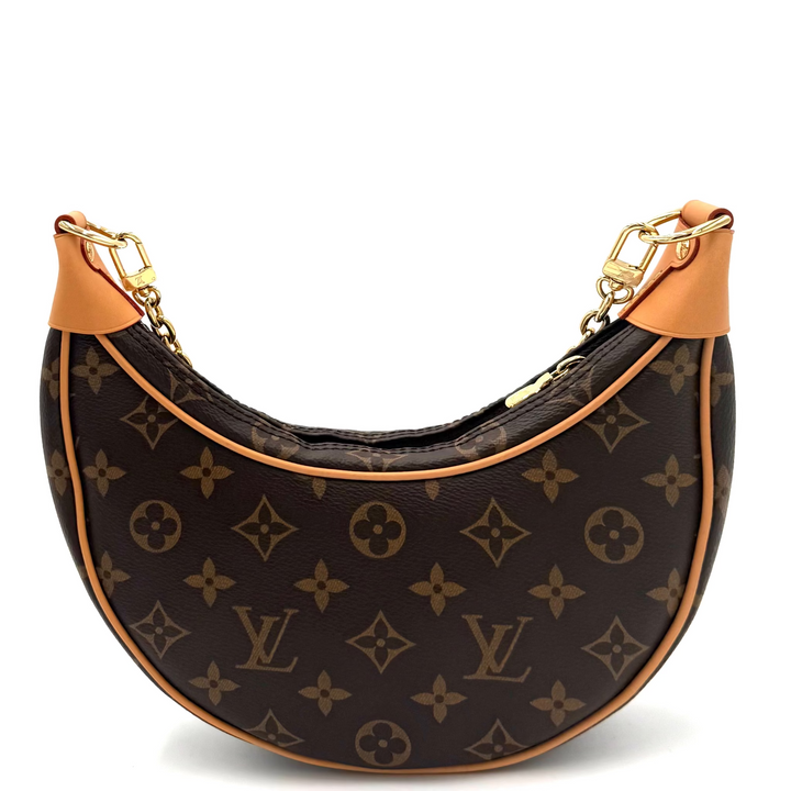 Louis Vuitton monogram canvas crescent shoulder bag with tan leather trim and gold-tone hardware, shown on a plain white background.