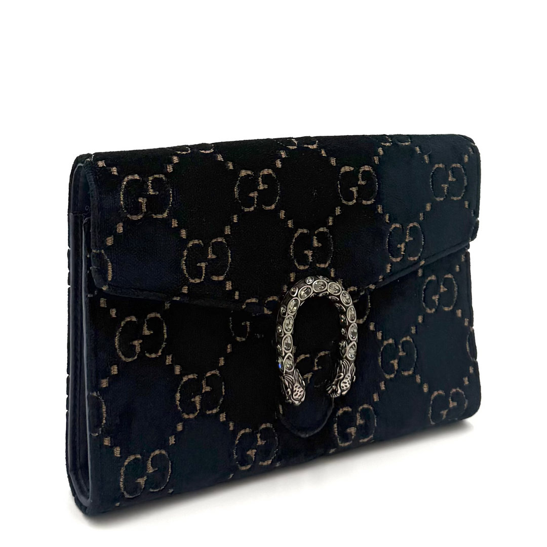 A dark navy blue velvet Gucci monogram wallet with a silver-tone horsebit clasp, displayed on a clean white background.