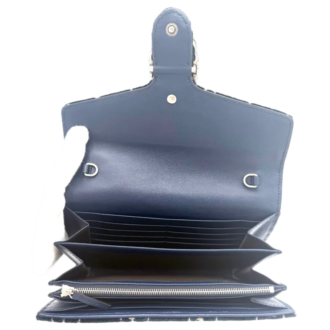 An open navy blue leather wallet or long wallet shown from the inside, featuring multiple card slots, a zippered compartment, and silver-tone hardware on a plain white background.