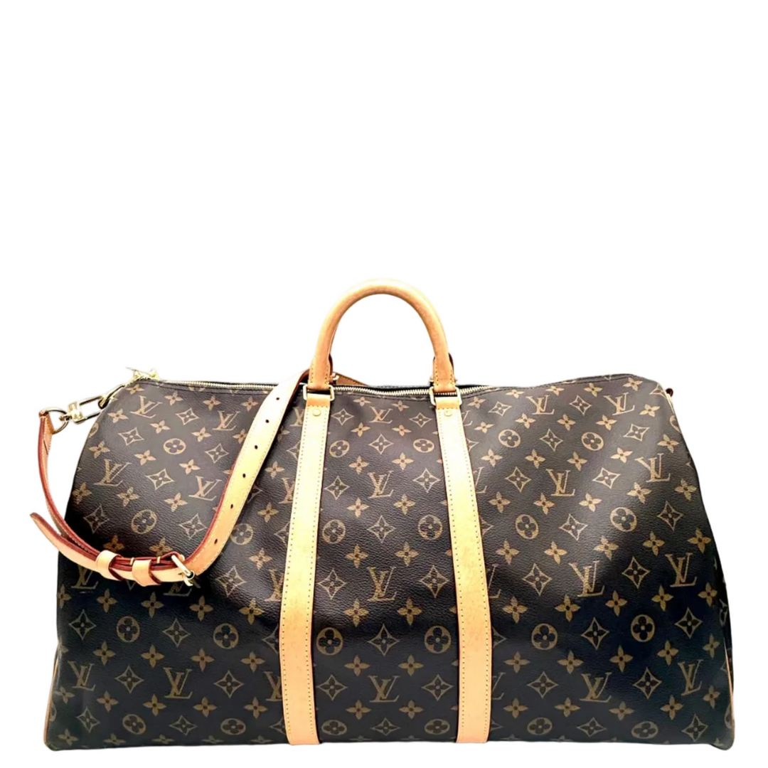 Louis Vuitton monogram canvas duffel bag with tan leather handles and side straps, shown on a plain white background.