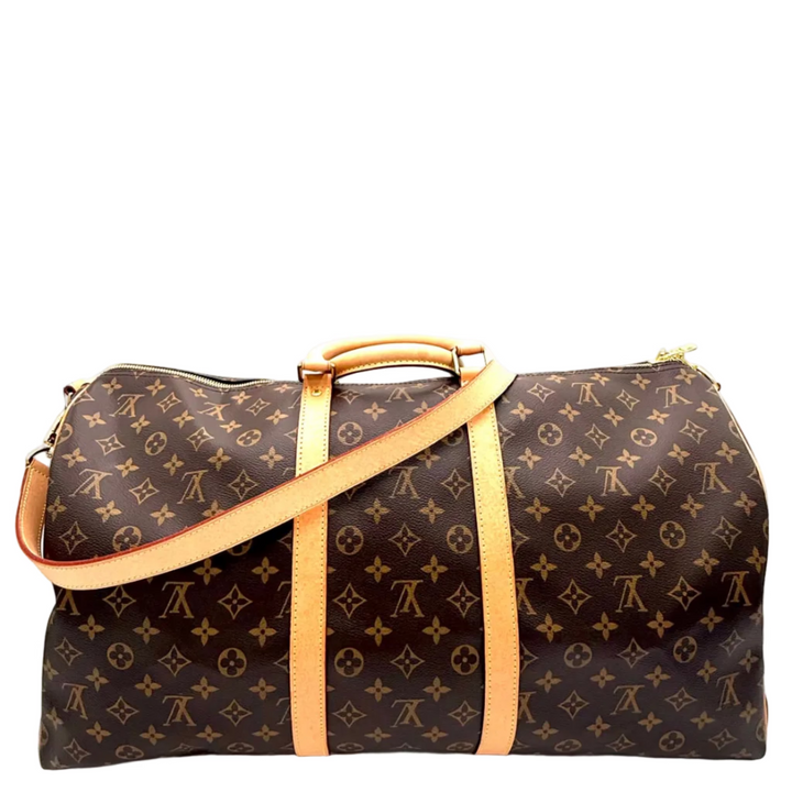 Louis Vuitton monogram canvas duffel bag with tan leather handles and shoulder strap, shown on a plain white background.