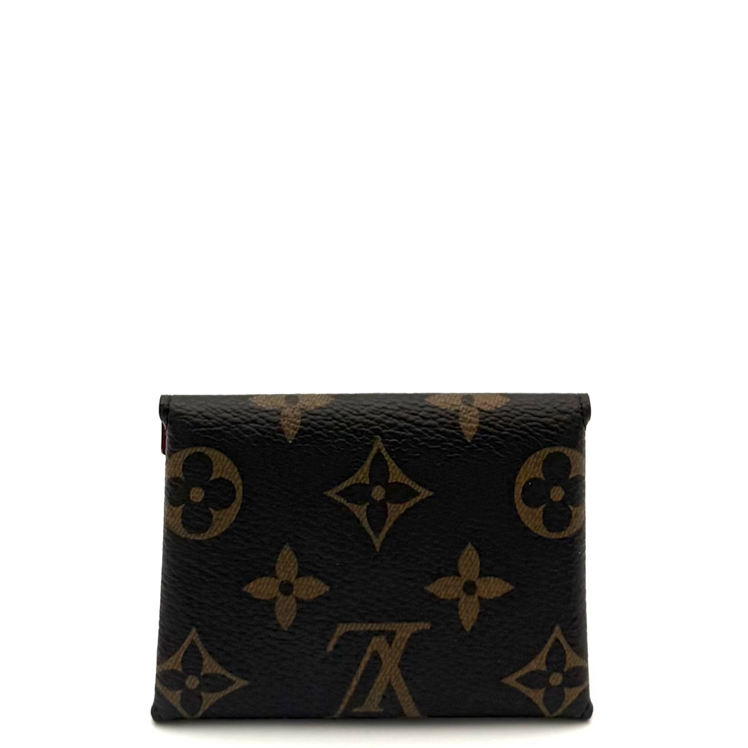A small Louis Vuitton monogram wallet in black coated canvas with gold-tone print, shown against a plain white background.