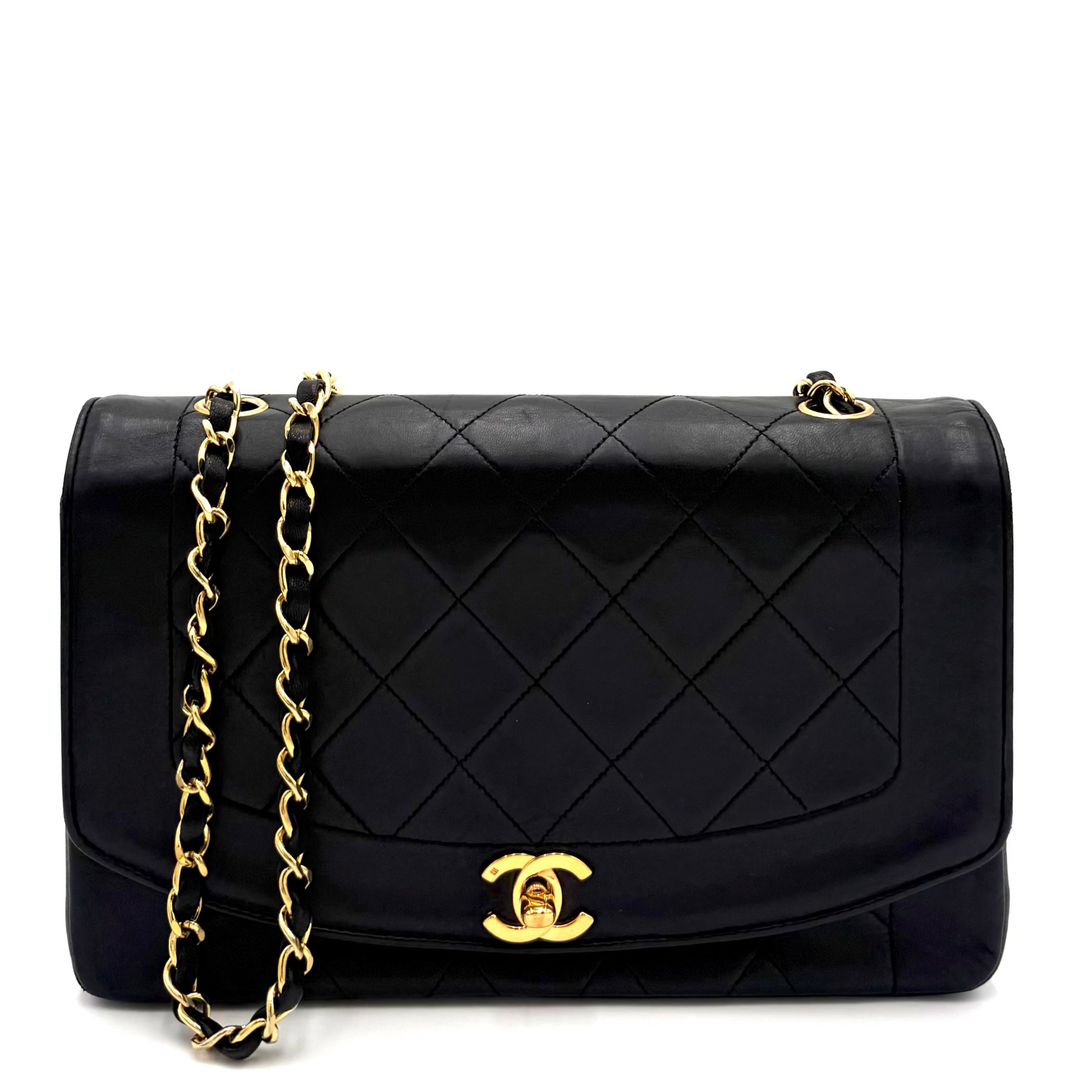 A black quilted leather Chanel flap bag with gold-tone hardware and a gold interlocking CC logo, displayed on a clean white background.