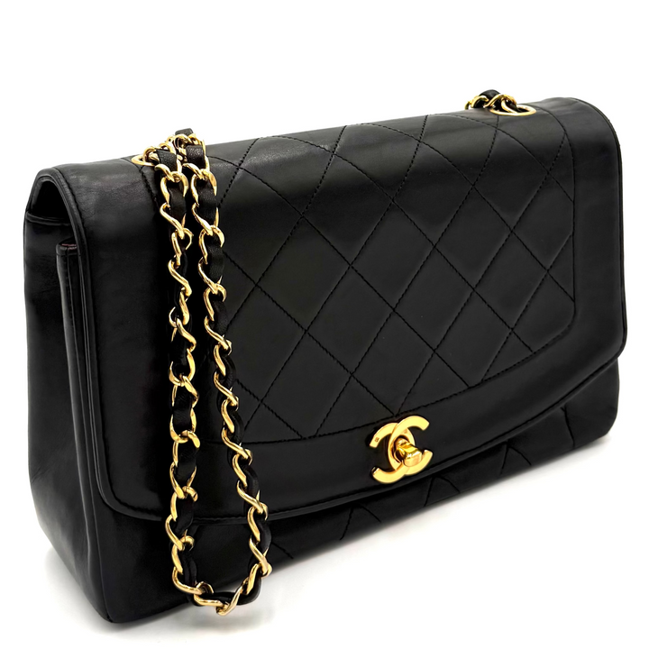 A black quilted leather Chanel flap bag with a gold-tone chain strap and interlocking CC logo, photographed on a white background.