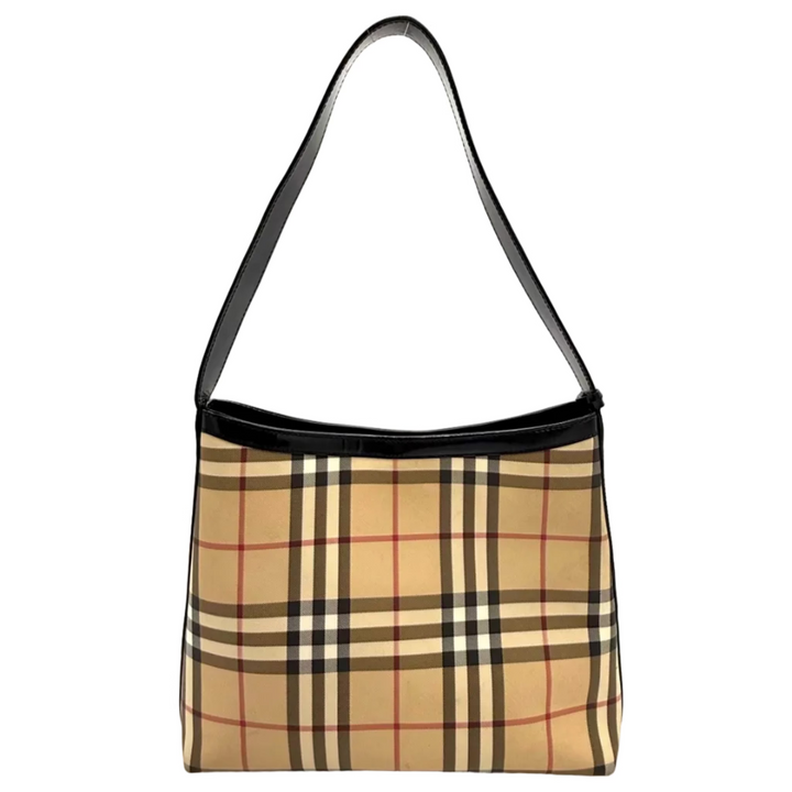A beige plaid shoulder bag with black trim and a black strap, held by a person's hand inside a white studio light box.